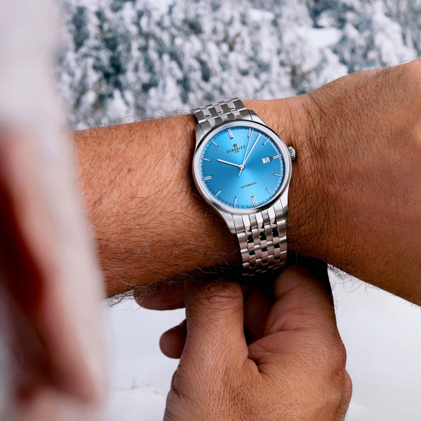 WEEKEND A1300/B by Perrelet features a crisp ice blue dial and timeless 3-hand design in stainless steel.